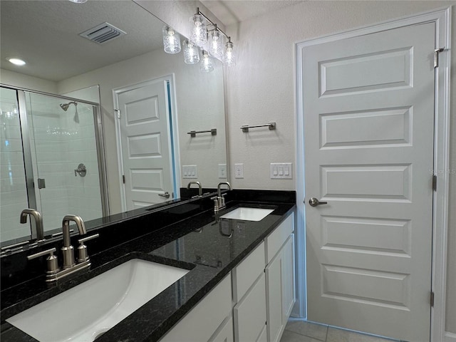 3891 Sagefield Dr, Harmony, FL 34773 - bathroom with double vanity, a stall shower, and tile patterned floors