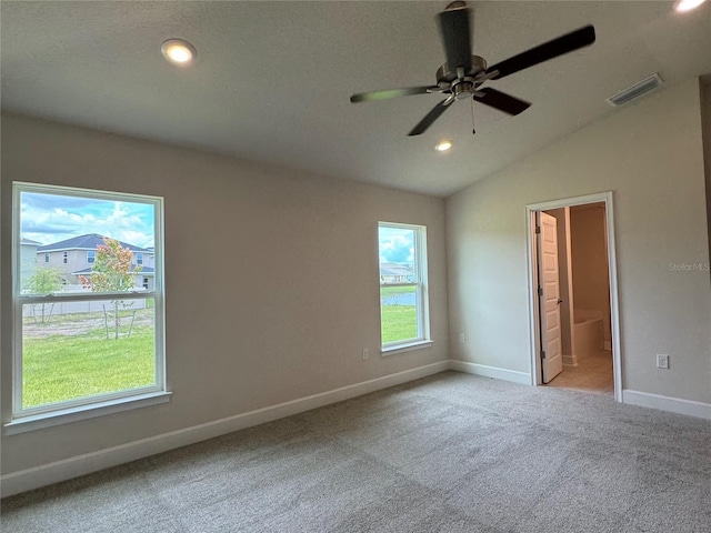 3891 Sagefield Dr, Harmony, FL 34773 - unfurnished bedroom featuring carpet, recessed lighting, ensuite bath, and lofted ceiling