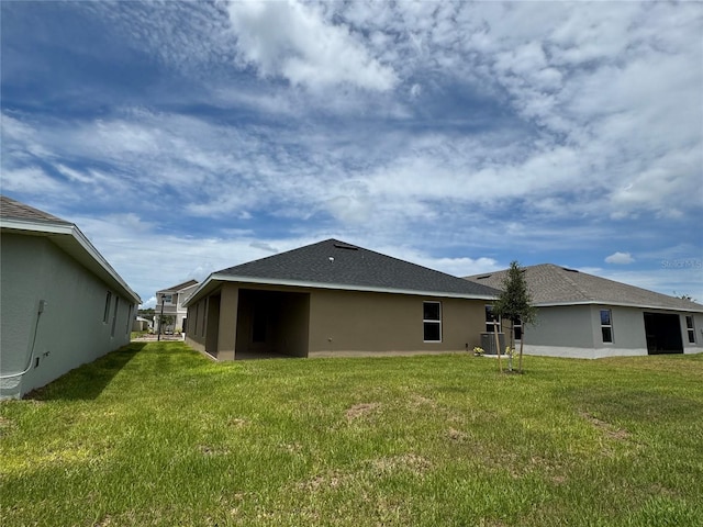 3891 Sagefield Dr, Harmony, FL 34773 - rear view of house with stucco siding and a yard