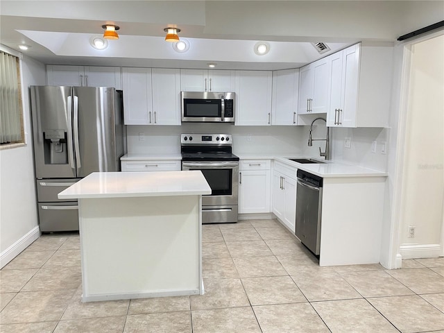508 Sandtree, Palm Beach Gardens, FL 33403 - kitchen with appliances with stainless steel finishes, light tile patterned floors, light countertops, a center island, and white cabinets