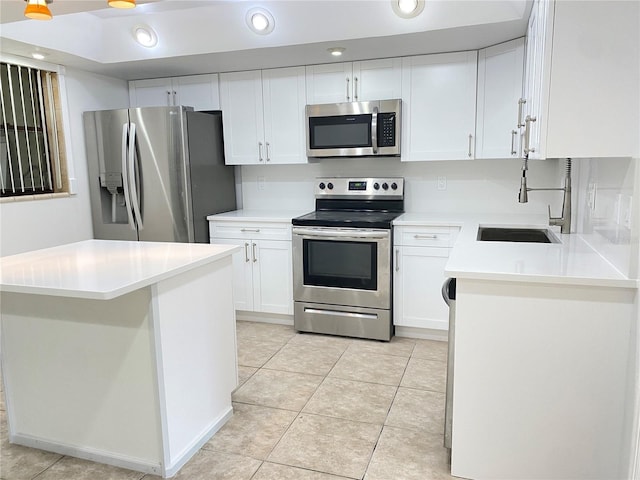 508 Sandtree, Palm Beach Gardens, FL 33403 - kitchen featuring stainless steel appliances, white cabinetry, light countertops, recessed lighting, and light tile patterned flooring