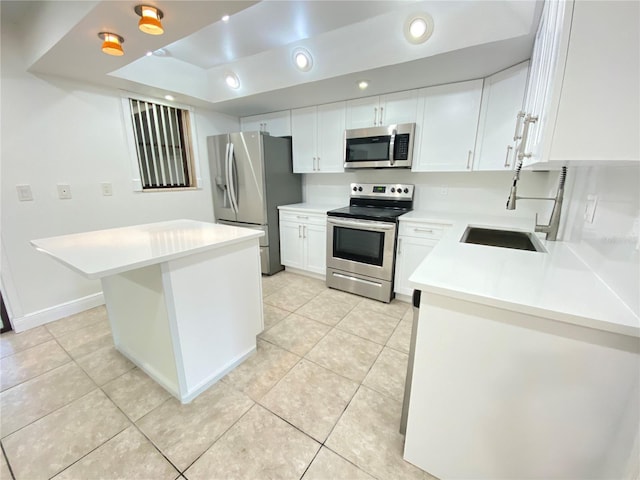 508 Sandtree, Palm Beach Gardens, FL 33403 - kitchen with appliances with stainless steel finishes, white cabinets, light tile patterned floors, light countertops, and recessed lighting