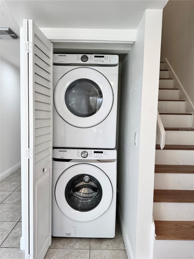 508 Sandtree, Palm Beach Gardens, FL 33403 - laundry area featuring estacked washer and dryer and tile patterned floors