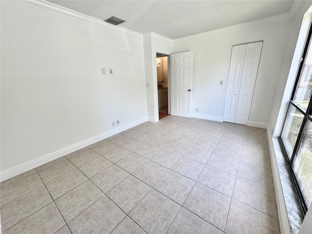 508 Sandtree, Palm Beach Gardens, FL 33403 - unfurnished bedroom featuring crown molding, light tile patterned floors, and a closet