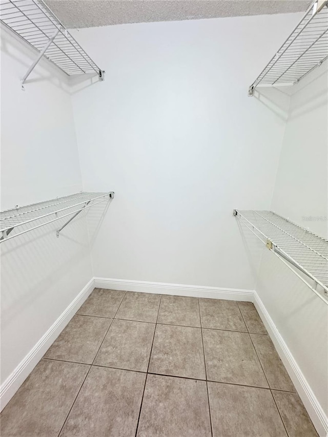 508 Sandtree, Palm Beach Gardens, FL 33403 - spacious closet featuring light tile patterned flooring