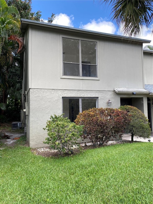508 Sandtree, Palm Beach Gardens, FL 33403 - view of side of property with a lawn and stucco siding