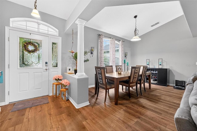 544 Lake Sumner Dr, Groveland, FL 34736 - dining space with ornate columns, lofted ceiling, and wood finished floors