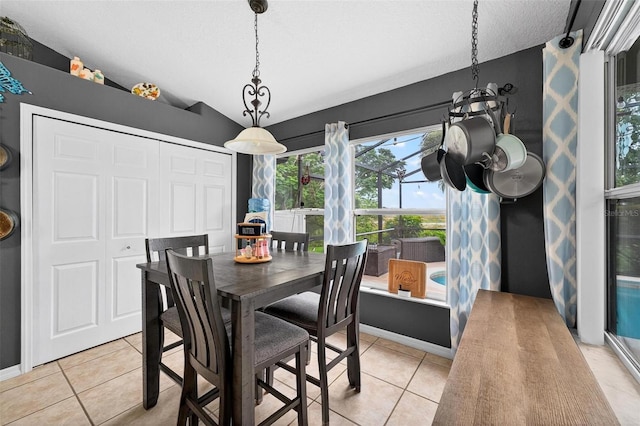 544 Lake Sumner Dr, Groveland, FL 34736 - dining space featuring vaulted ceiling, light tile patterned floors, plenty of natural light, and a chandelier