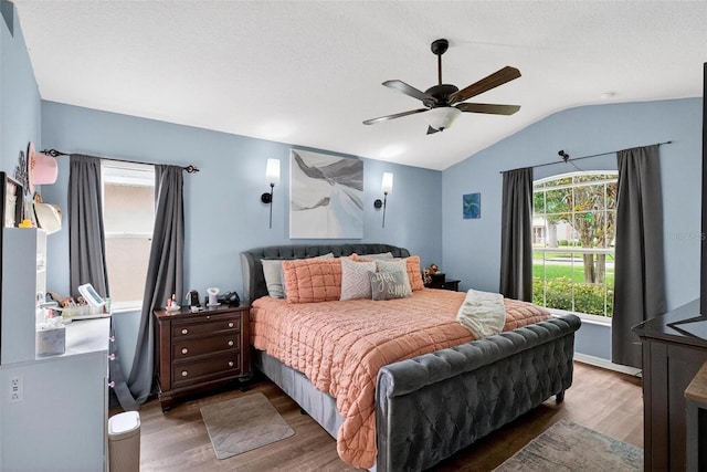 544 Lake Sumner Dr, Groveland, FL 34736 - bedroom featuring wood finished floors, multiple windows, vaulted ceiling, and a ceiling fan