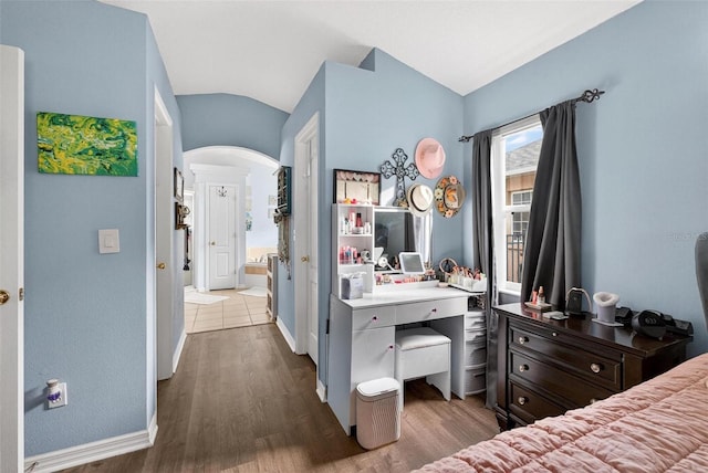 544 Lake Sumner Dr, Groveland, FL 34736 - bedroom with arched walkways, dark wood-type flooring, and vaulted ceiling