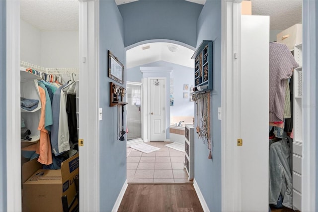 544 Lake Sumner Dr, Groveland, FL 34736 - corridor with arched walkways, a textured ceiling, and wood finished floors