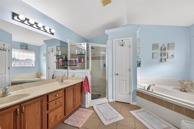 544 Lake Sumner Dr, Groveland, FL 34736 - bathroom with tile patterned flooring, a bath, a stall shower, double vanity, and vaulted ceiling