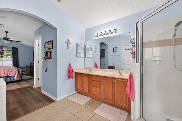 544 Lake Sumner Dr, Groveland, FL 34736 - full bath featuring ensuite bathroom, lofted ceiling, ceiling fan, a shower stall, and double vanity