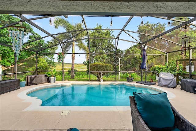544 Lake Sumner Dr, Groveland, FL 34736 - outdoor pool featuring glass enclosure, a patio area, and a grill