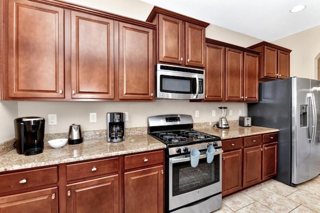4123 Oaktree Dr, Davenport, FL 33837 - kitchen with appliances with stainless steel finishes, light tile patterned flooring, light stone counters, and recessed lighting