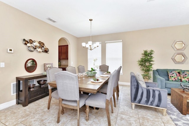 4123 Oaktree Dr, Davenport, FL 33837 - dining area with a chandelier, arched walkways, and light tile patterned floors