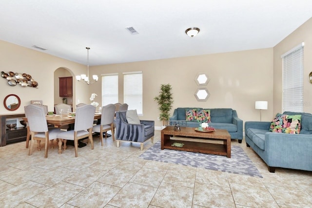 4123 Oaktree Dr, Davenport, FL 33837 - living room featuring a chandelier and arched walkways