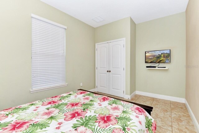 4123 Oaktree Dr, Davenport, FL 33837 - bedroom with a closet and light tile patterned floors