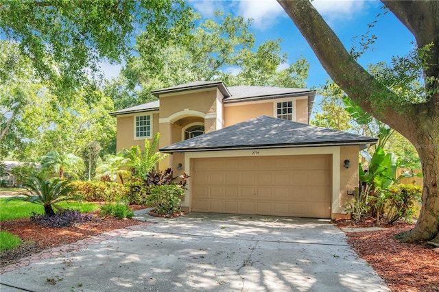 2794 Cullens Ct, Ocoee, FL 34761 - view of front of house featuring driveway, stucco siding, a garage, and a shingled roof