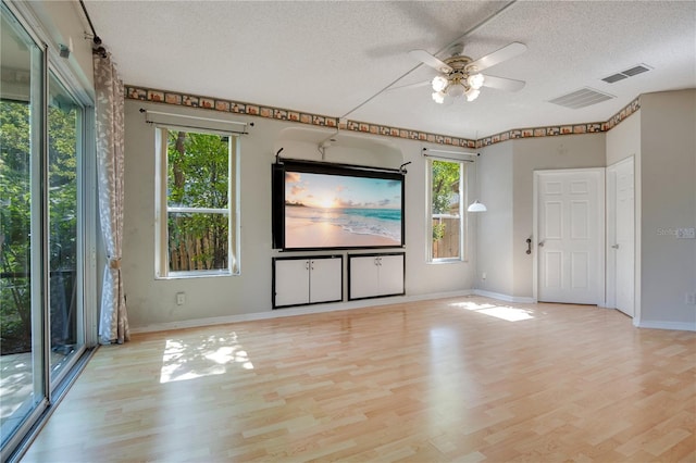 2794 Cullens Ct, Ocoee, FL 34761 - unfurnished living room with a textured ceiling, plenty of natural light, light wood finished floors, and ceiling fan