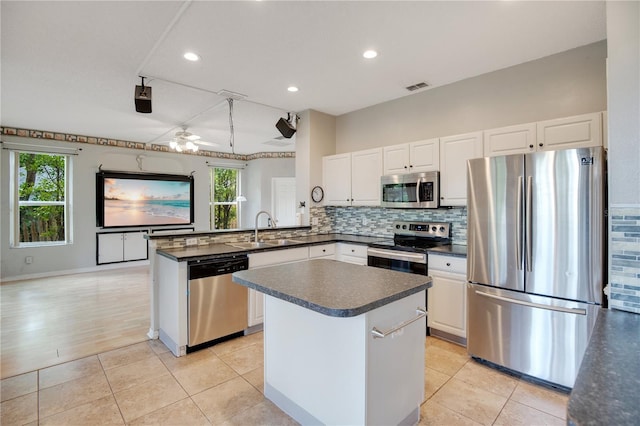 2794 Cullens Ct, Ocoee, FL 34761 - kitchen featuring appliances with stainless steel finishes, dark countertops, tasteful backsplash, white cabinetry, and recessed lighting