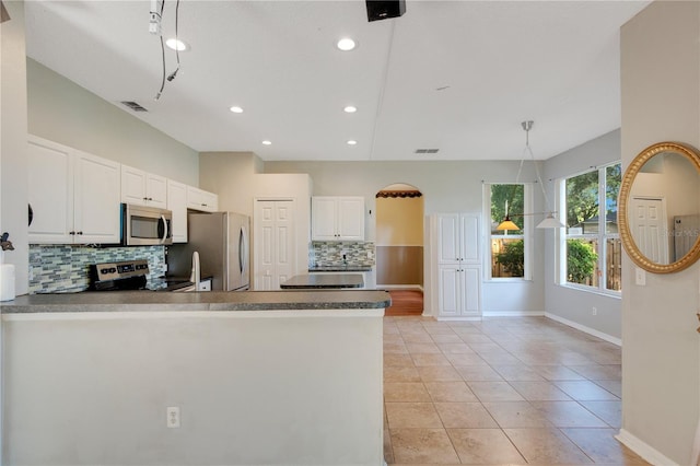 2794 Cullens Ct, Ocoee, FL 34761 - kitchen featuring stainless steel appliances, backsplash, a peninsula, white cabinets, and light tile patterned flooring