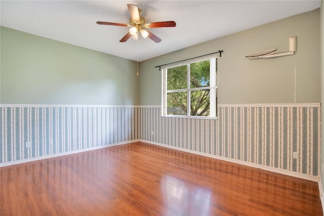 2794 Cullens Ct, Ocoee, FL 34761 - spare room featuring a wainscoted wall, wood finished floors, ceiling fan, and a textured ceiling