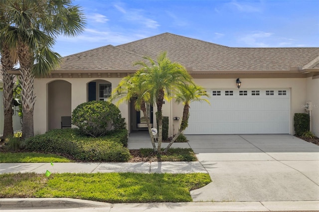11402 Peckham Pl, Tampa, FL 33625 - view of front of property with stucco siding, driveway, a garage, and roof with shingles