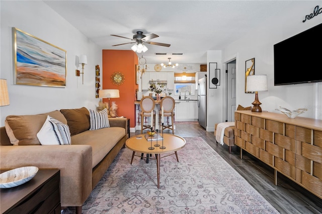 1100 E Caroline St Unit 204, Tavares, FL 32778 - living area with a ceiling fan, a chandelier, and wood finished floors