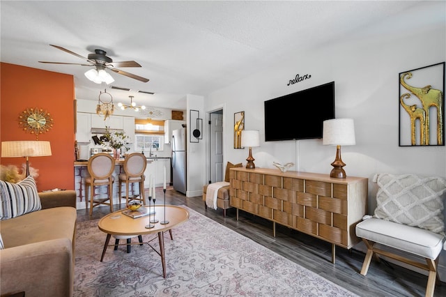 1100 E Caroline St Unit 204, Tavares, FL 32778 - living area with ceiling fan, a chandelier, and dark wood-type flooring