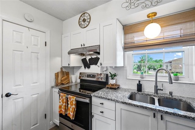 1100 E Caroline St Unit 204, Tavares, FL 32778 - kitchen with stainless steel electric stove, under cabinet range hood, white cabinets, and decorative backsplash