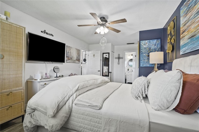 1100 E Caroline St Unit 204, Tavares, FL 32778 - bedroom featuring ceiling fan, dark wood-type flooring, and ensuite bathroom