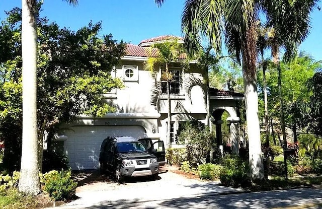 143 NW 117th Ave, Plantation, FL 33325 - view of front of home with concrete driveway, a garage, and a tile roof