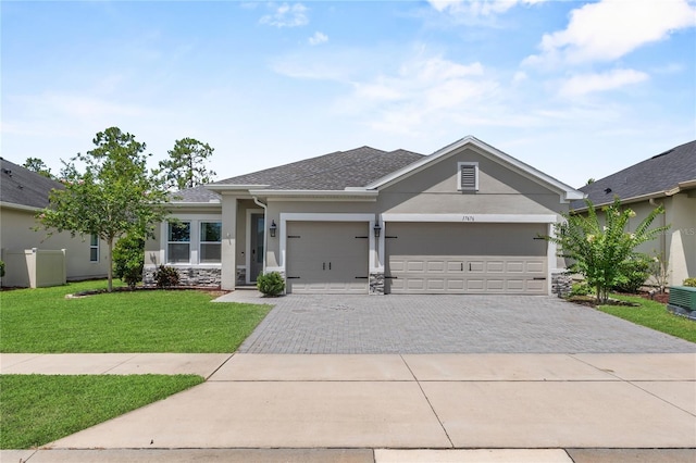 17676 Passionflower Cir, Clermont, FL 34714 - single story home featuring driveway, stucco siding, a garage, a front yard, and stone siding