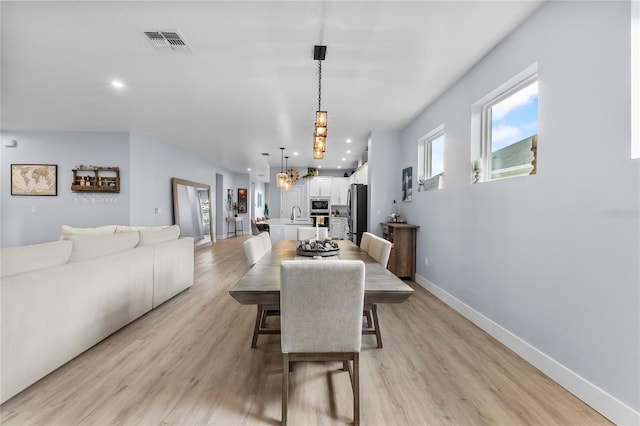 17676 Passionflower Cir, Clermont, FL 34714 - dining room with light wood-type flooring, plenty of natural light, recessed lighting, and a chandelier