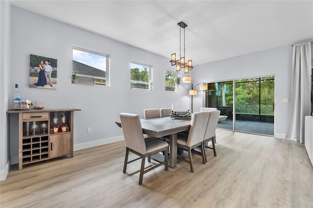 17676 Passionflower Cir, Clermont, FL 34714 - dining area featuring a chandelier and light wood-style flooring