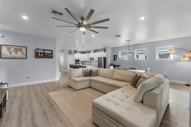 17676 Passionflower Cir, Clermont, FL 34714 - living area with a ceiling fan, a chandelier, light wood-style flooring, and recessed lighting