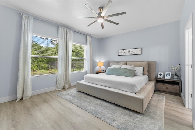 17676 Passionflower Cir, Clermont, FL 34714 - bedroom with light wood-style floors and a ceiling fan