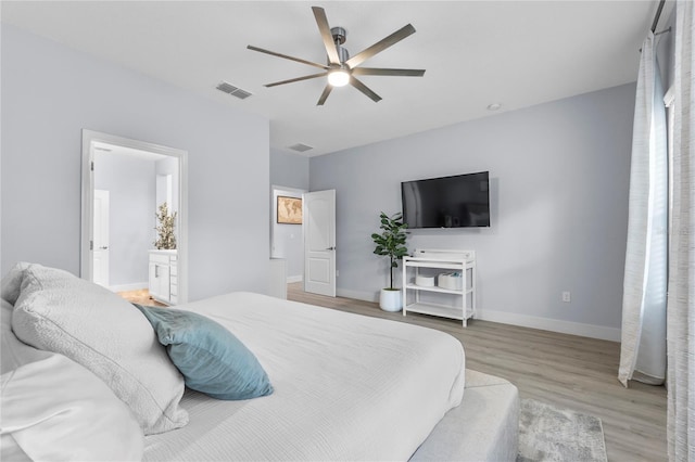 17676 Passionflower Cir, Clermont, FL 34714 - bedroom with wood finished floors, ceiling fan, and ensuite bathroom