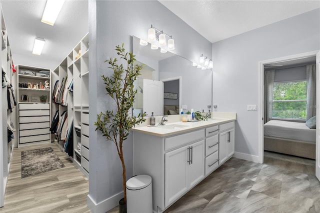17676 Passionflower Cir, Clermont, FL 34714 - full bath featuring double vanity, a walk in closet, ensuite bath, and wood finished floors