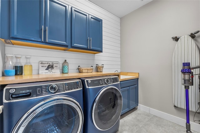 17676 Passionflower Cir, Clermont, FL 34714 - washroom with separate washer and dryer, cabinet space, and wood walls