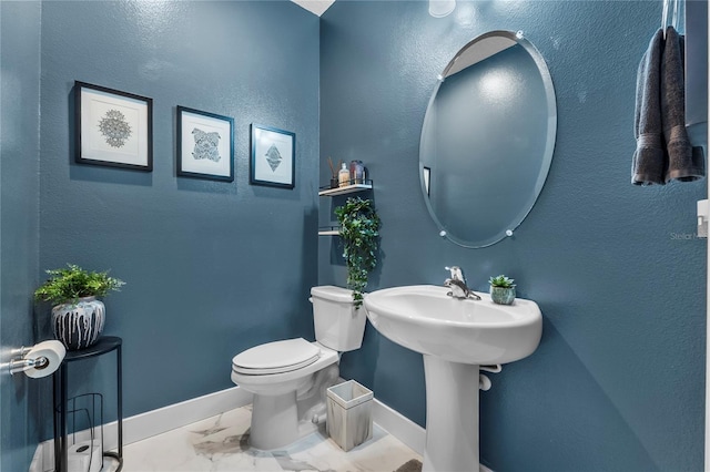 17676 Passionflower Cir, Clermont, FL 34714 - half bathroom with baseboards and marble look tile flooring