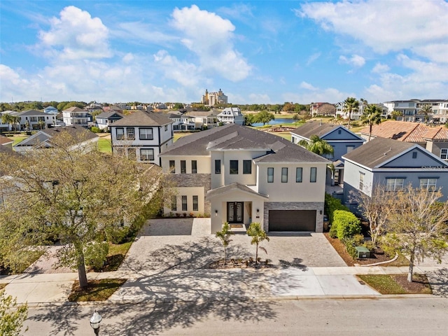 1526 Euston Dr, Reunion, FL 34747 - view of front of home with a residential view, decorative driveway, a garage, and stucco siding