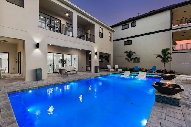 1526 Euston Dr, Reunion, FL 34747 - swimming pool with an outdoor living space with a fire pit and a patio
