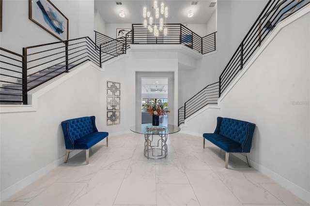 1526 Euston Dr, Reunion, FL 34747 - entrance foyer featuring stairs, a chandelier, a high ceiling, and marble look tiles