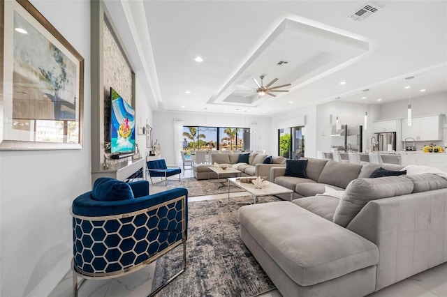 1526 Euston Dr, Reunion, FL 34747 - living area with a tray ceiling, ceiling fan, and recessed lighting