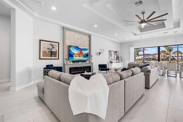 1526 Euston Dr, Reunion, FL 34747 - living room with a raised ceiling, light marble finish floors, a ceiling fan, and recessed lighting