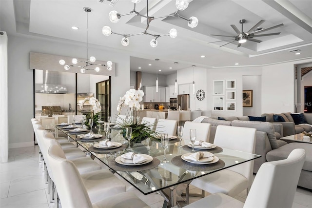 1526 Euston Dr, Reunion, FL 34747 - dining area with recessed lighting, a tray ceiling, a chandelier, ceiling fan, and light marble finish floors