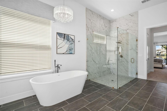 1526 Euston Dr, Reunion, FL 34747 - bathroom with a marble finish shower, a freestanding tub, a chandelier, and recessed lighting