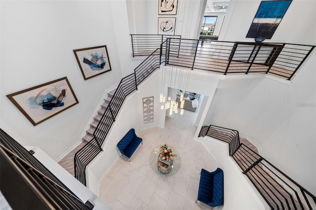1526 Euston Dr, Reunion, FL 34747 - staircase with marble finish floors and a high ceiling